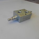 Anti-shock valve for snow plow blades